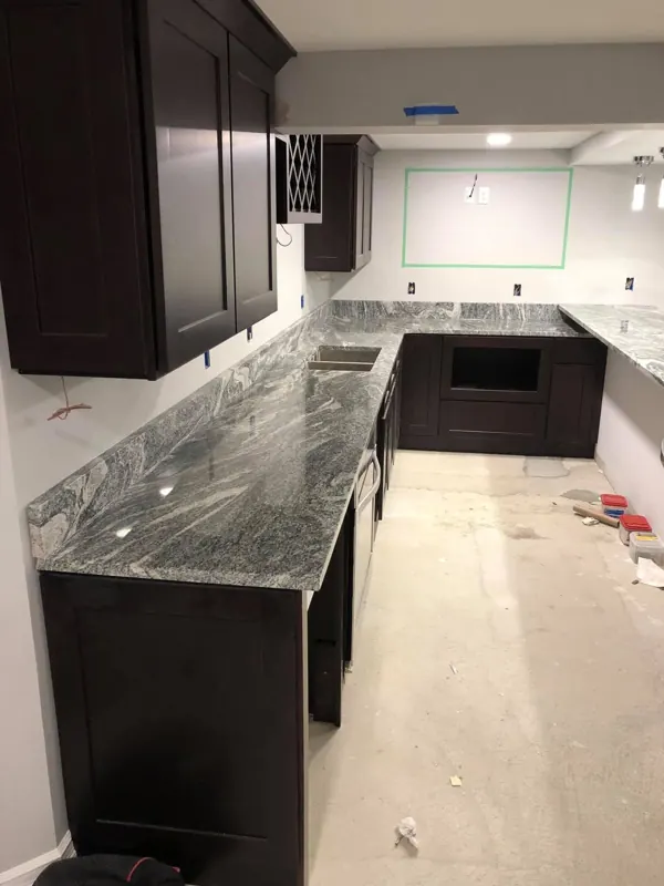Gray granite counters on dark cabinets during install