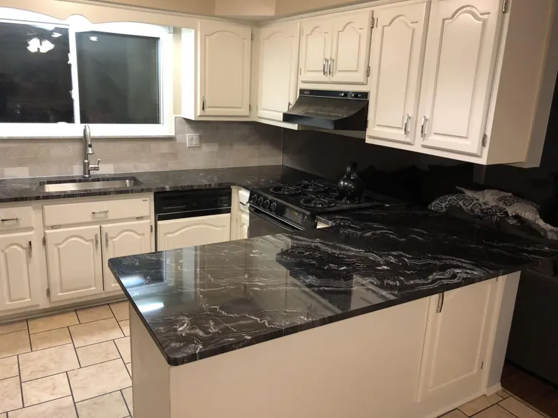 White kitchen with a dark granite island