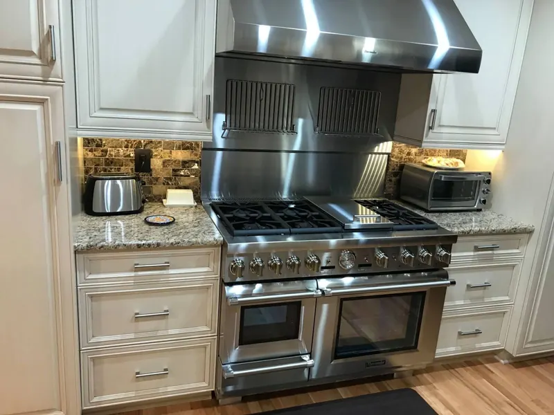 Kitchen with white cabinets, granite counters and a center island